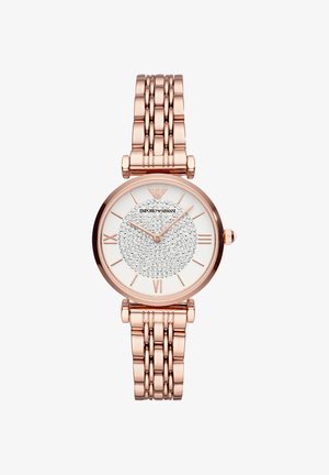 Montre en métal or rose avec bracelet à maillons, cadran blanc avec ornements en cristal, chiffres romains et deux aiguilles fines indiquant 10h08.