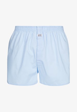 Boxer in cotone azzurro chiaro con vita elasticizzata, piccola apertura frontale e etichetta cucita sulla cintura. Texture liscia.