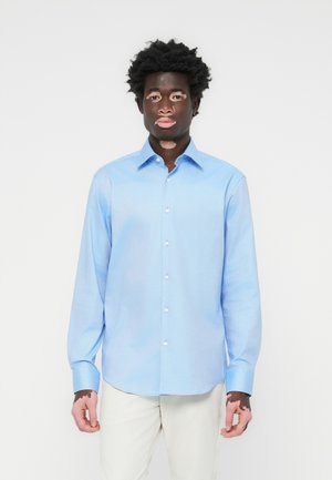 Light blue button-up shirt with a collar, long sleeves, and white buttons, featuring a smooth texture and straight hemline.