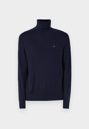Marineblå turtleneck sweater lavet af blødt strikstof, med lange ærmer og et lille logoaccent på brystet.