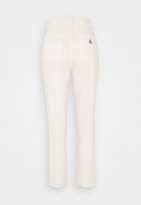 High-waisted off-white straight-leg jeans with two back pockets and a small brown triangular patch on the right pocket.