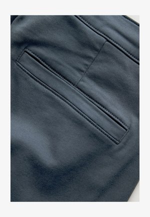 Dark gray fabric featuring smooth texture, with a single back pocket and subtle stitching details. No visible patterns or hardware.