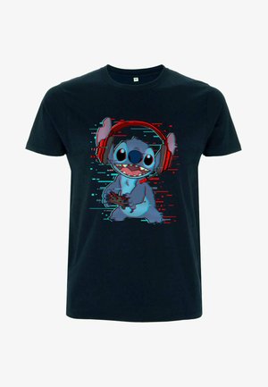 T-shirt in cotone nero con un personaggio dei cartoni animati dalla pelle blu, cuffie rosse e un controller per videogiochi, sullo sfondo di un glitch digitale.