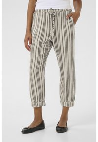 Beige striped pants with black vertical stripes, featuring an elastic waistband, adjustable drawstring, and cuffed hems.