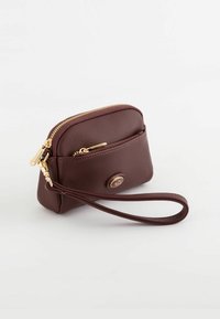 Brown textured leather pouch with gold zippers, two compartments, and a wrist strap. Features a round logo on the front.