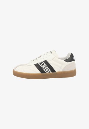 White leather sneaker with black stripes and branding, gum rubber sole, round toe, and lace-up design. Smooth texture with padded collar.