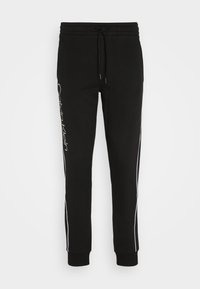 Zwarte joggers gemaakt van een katoenmix, met een trekkoord in de taille, witte zijstrepen en een geborduurd logo op het linkerbeen.