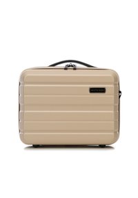 Valigia rigida beige con finitura texturizzata, scanalature orizzontali, zip nera e dettaglio del logo. Progettata per resistenza e facile maneggevolezza.