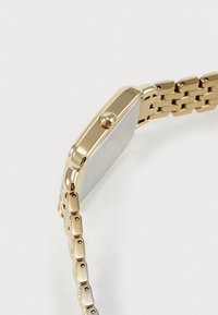 Gullfarget klokke med rektangulært hus, teksturert sølvfarget skive, og lenkedesign i metallarmbånd. Har en liten krone for justeringer.