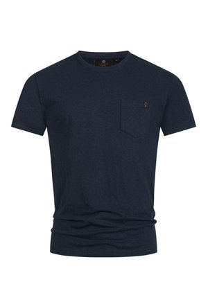 T-shirt en coton bleu marine foncé avec des manches courtes, col rond et une petite poche sur la poitrine. Texture douce avec un léger extensibilité.
