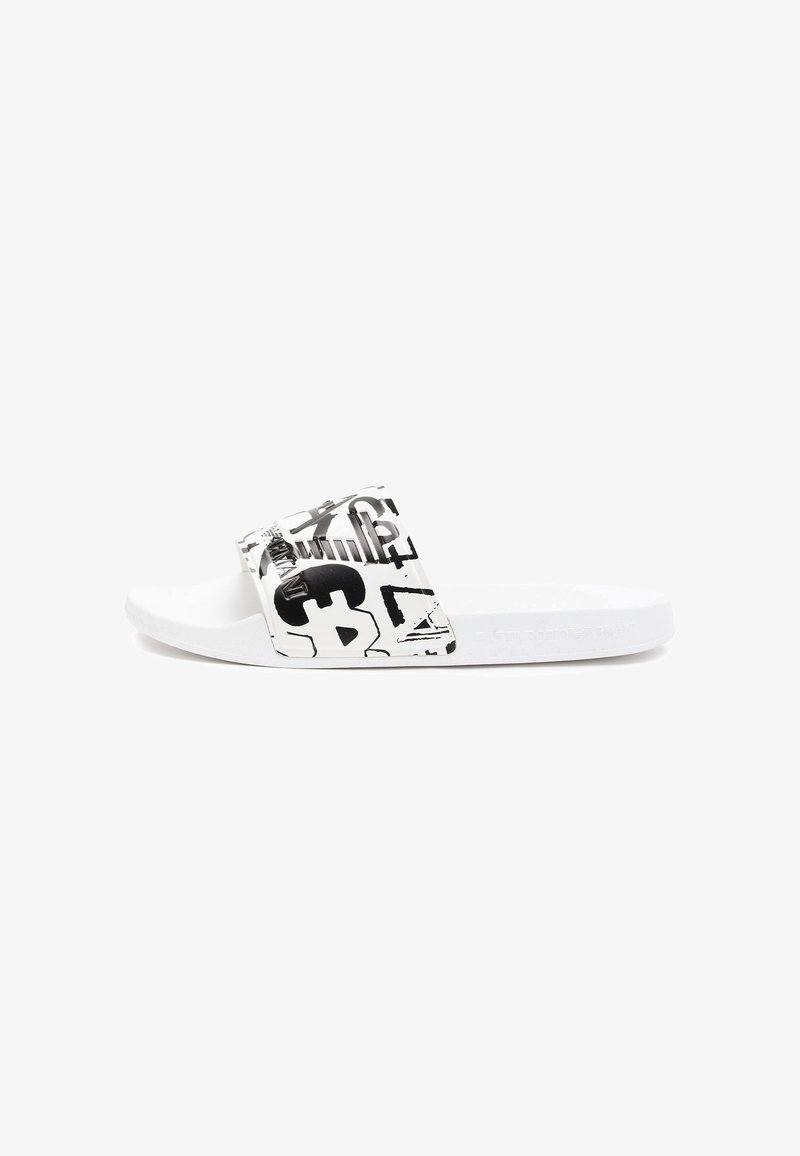 White slide sandal with a textured strap featuring black graphic patterns. Flat sole design, minimalist style, lightweight material.