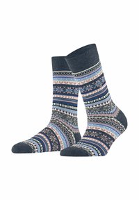Chaussettes de longueur mi-mollet avec des motifs géométriques et floraux multicolores en bleu, rose, noir et blanc sur un fond bleu marine foncé.