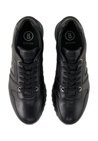 Black leather sneakers with a smooth texture, lace-up design, silver eyelets, and logo on the insole. Rounded toe and padded collar.