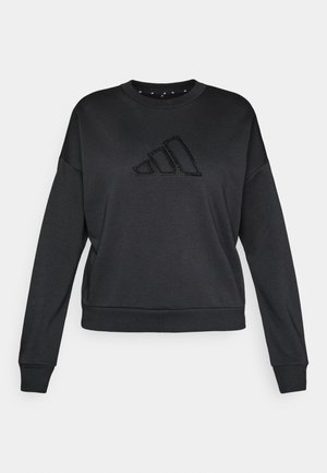 Svart hettegenser laget av myk stoff, med rund hals, lange ermer og et frontlogo med skinnende detaljer.