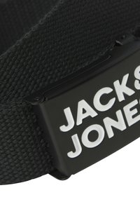Black fabric belt featuring a matte black buckle with raised white lettering "JACK & JONES." Textured surface with woven details.