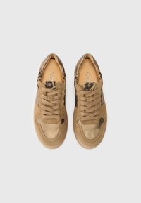 Tan sneakers with leopard print accents, suede and smooth leather materials, round toe, and flat laces. Light-colored rubber sole.