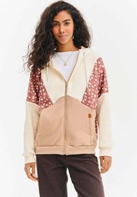 Bluza z kapturem na zamek błyskawiczny w kolorach kremowym, różowym i brązowym, z wzorzystym motywem, kieszeniami typu kangur oraz ściągaczami przy rękawach.