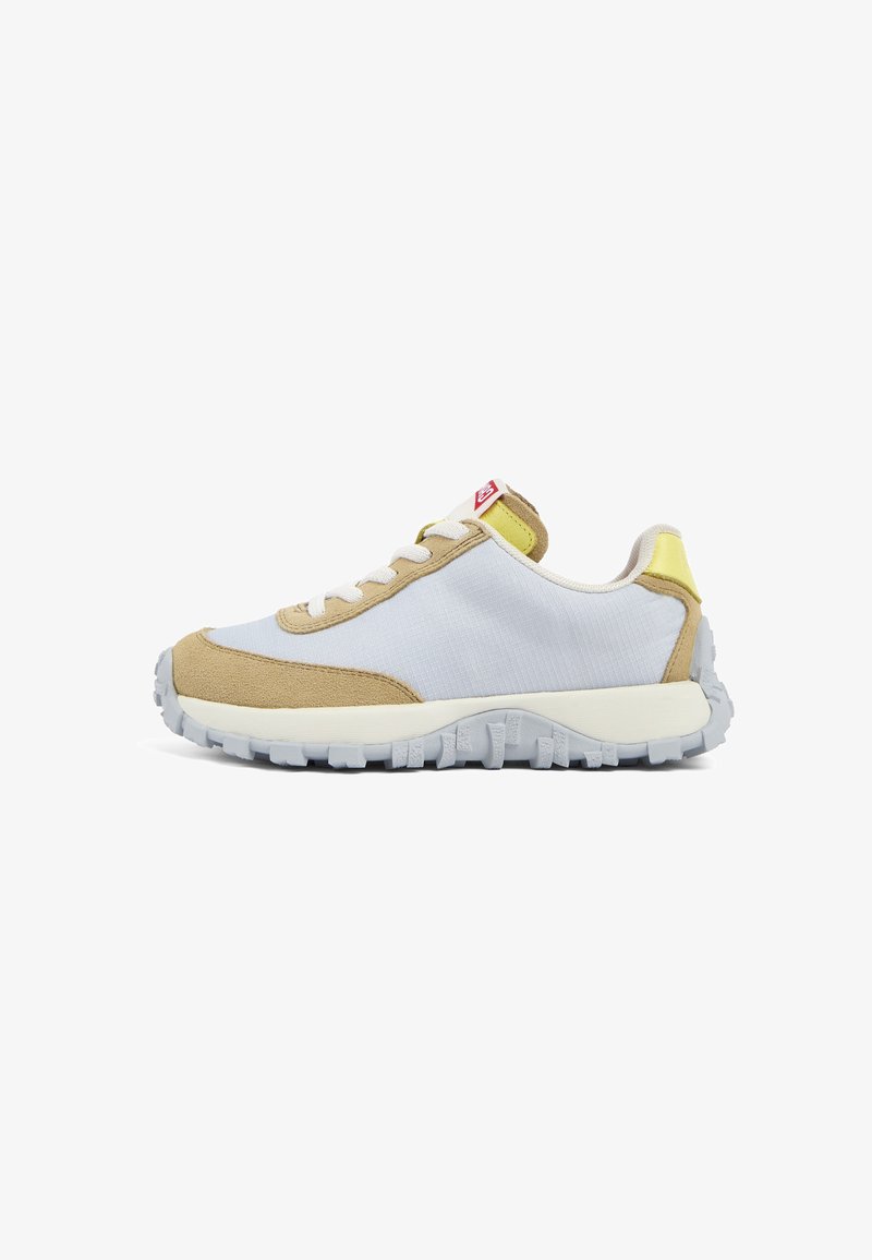 Lace-up sneaker with a white fabric upper and tan suede accents, yellow heel tab, and textured grey outsole. Features a red logo on tongue.