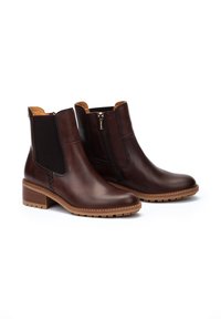 Bottines en cuir marron avec des panneaux élastiques sur les côtés, une fermeture éclair sur le côté, un talon empilé et des détails cousus le long des côtés.