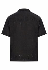Short-sleeve black shirt featuring a textured pattern with cut-outs, geometric shapes, and floral designs, crafted from lightweight fabric.