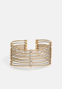Cuff bracelet made of intertwined gold and silver cable, featuring three clear gemstones on a central bar. Open design with a curved edge.