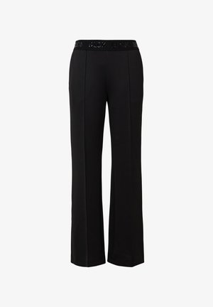 Black wide-leg trousers with a flat waistband featuring raised lettering. Made of a smooth fabric, they have a relaxed fit and no pockets.
