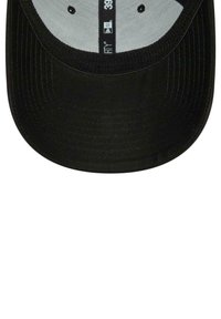 Black cap with a curved brim, textured fabric, and a light gray inner lining. Features black stitching and ventilation holes.