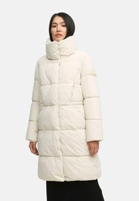 Puffy white long coat with a high collar, featuring a quilted design and side pockets. Soft, smooth texture with a minimalistic style.