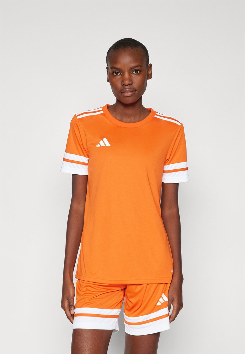 Oranje sportshirt en short set, met witte accenten en horizontale strepen, gemaakt van een gladde, lichte stof.