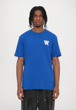 Royal blue short-sleeve t-shirt with a round neckline and white "W" logo on the left chest. Features a relaxed fit and cotton-like texture.