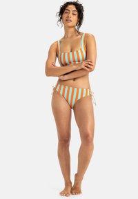 Bikini-Set mit orange-blauen vertikalen Streifen. Das Oberteil hat einen quadratischen Ausschnitt, und das Unterteil besitzt verstellbare seitliche Bindebänder. Glatte Stofftextur.