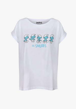 T-shirt blanc à manches courtes avec des schtroumpfs bleus au design cartoon en train de marcher. Le design comprend des contours noirs et le texte "les SCHTROUMPFS" en dessous des personnages.