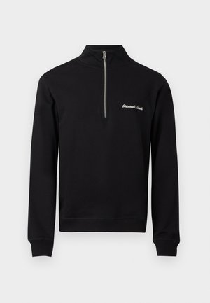 Sweat-shirt noir avec une demi-fermeture éclair et un col haut, arborant le texte brodé en blanc "Originals Canada" sur la zone gauche de la poitrine.