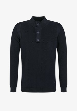 Temno modra pletena dolga srajca s dolgimi rokavi in ribastim ovratnikom ter žepkom z vseh treh gumbov, ki ima značilno teksturirano chevron vzorčasto površino.