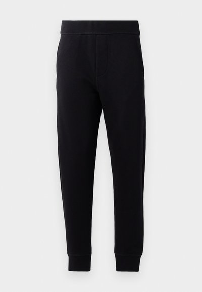 Čierne jogger nohavice vyrobené z jemnej tkaniny, s elastickým pásom, slim fit, bočnými vreckami a zúženými manžetami na členkoch.