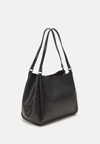 Black leather tote bag with a smooth finish, rounded shape, two shoulder straps, and a side zip pocket for added storage.