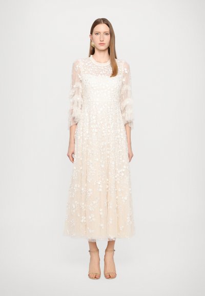 Mid-length, beige dress with sheer, embroidered floral pattern. Ruffled, translucent sleeves and a fitted bodice. Elegant and airy design.