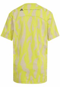 Gul idrottströja med en tonad beige tigerstrimma. Har korta ärmar och en broderad logotyp på bakre axeln.