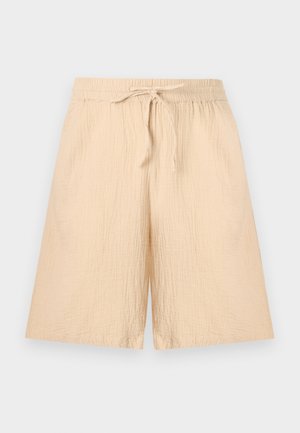 Ανοιχτό μπεζ φαρδιά σορτς με ελαστική μέση και κορδόνι, κατασκευασμένα από τσαλακωμένο ύφασμα κατάλληλο για καθημερινή χρήση.