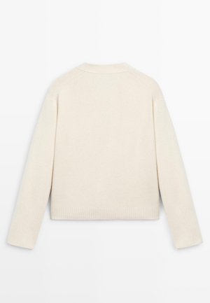 Maglione lavorato a maglia color crema con scollo a girocollo, maniche raglan, polsini e orlo a costine, caratterizzato da una finitura morbida e testurizzata.
