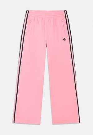 Pink athletic pants with a textured fabric, featuring black side stripes and zippered pockets. Elastic waistband for comfort.