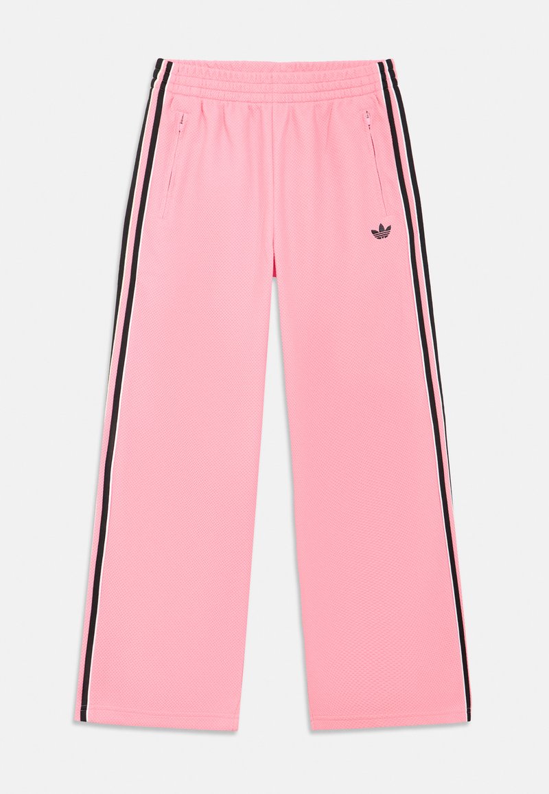 Roze sportbroek met een textuurstof, voorzien van zwarte zijstrepen en zakken met rits. Elastische tailleband voor comfort.
