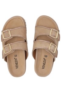 Beige slip-on sandals with two adjustable straps, adorned with gold-tone buckles and a textured footbed. Soft suede material.