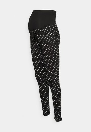 Leggings de maternidade pretos com uma cintura alta elástica, apresentando um padrão de gota branco, ajuste slim e tecido macio e texturizado.