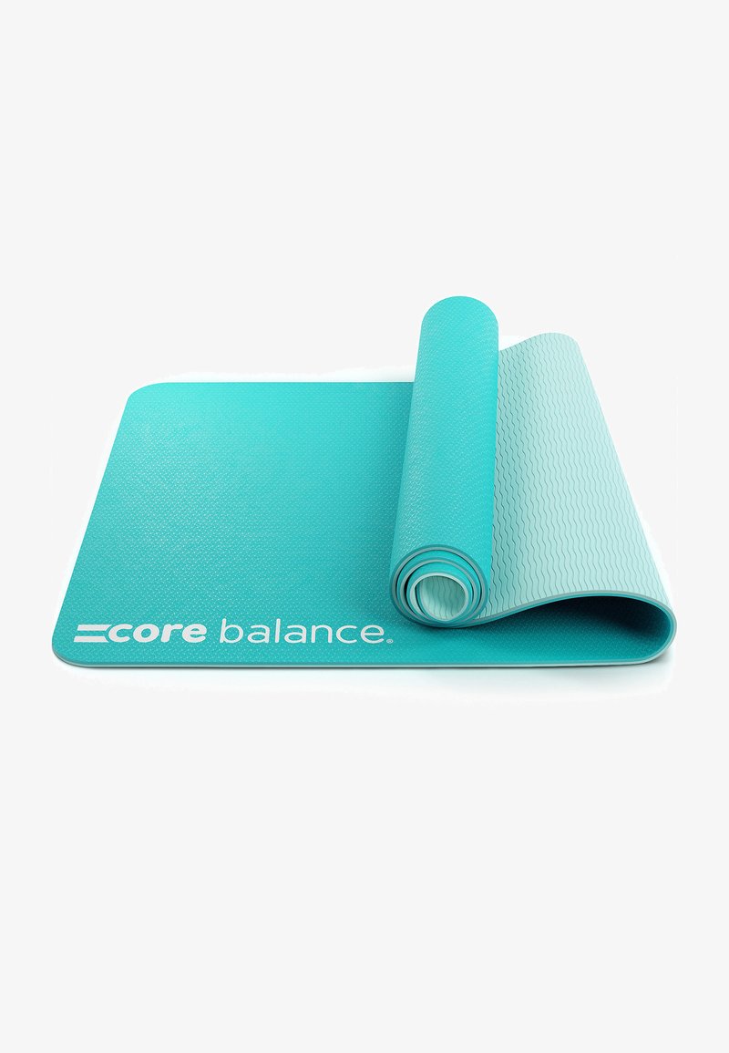 Tappetino da esercizio turchese con superficie testurizzata, parzialmente arrotolato. Presenta il marchio "core balance" in bianco su un bordo.
