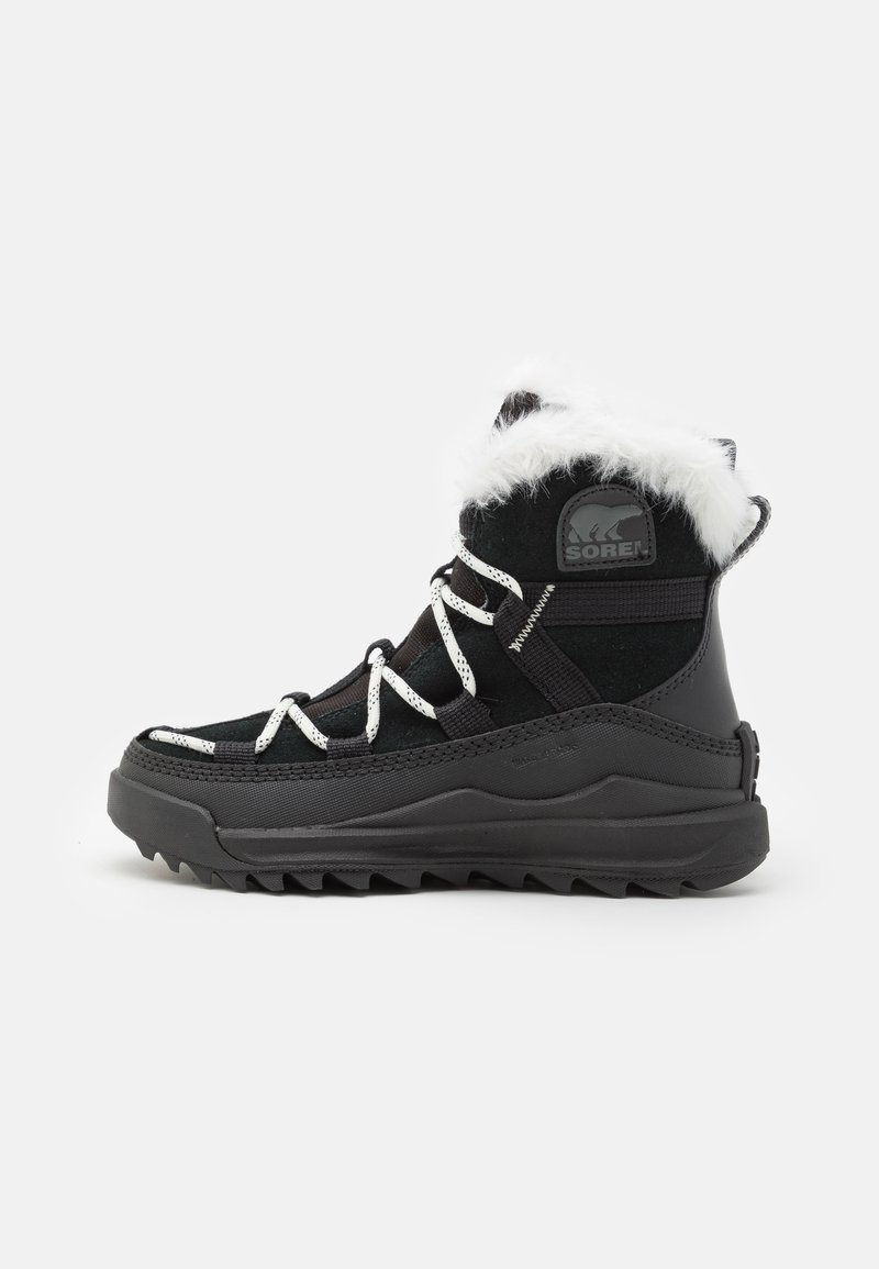 Black winter boots with faux fur trim, rubber sole, and white laces. Features a waterproof exterior and a rugged tread pattern for grip.