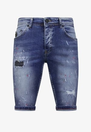 Denim shorts in vervaagd blauw, met versleten delen, subtiele verfspetters, opgerolde manchetten en een vijf-pocket ontwerp met ritssluiting.