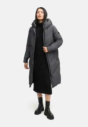 Long, gray puffer coat with a hood, front snap closure, and side pockets, worn over a black ribbed dress and black boots. Smooth texture.