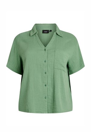 Krátký rukáv, světle zelená texturovaná košile na knoflíky s límečkem a náprsní kapsou, volný střih.