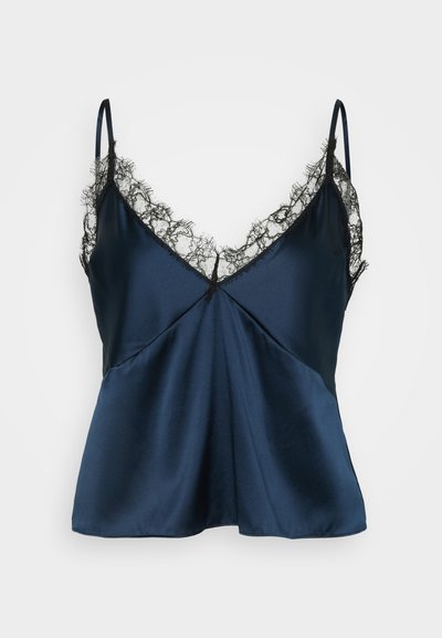 Jūras kāja satīna kamzolis ar melnu mežģīņu apdari ap V veida izgriezumu un siksniņām. Plūstoša piegriezuma forma ar dekoratīvām šuvēm.